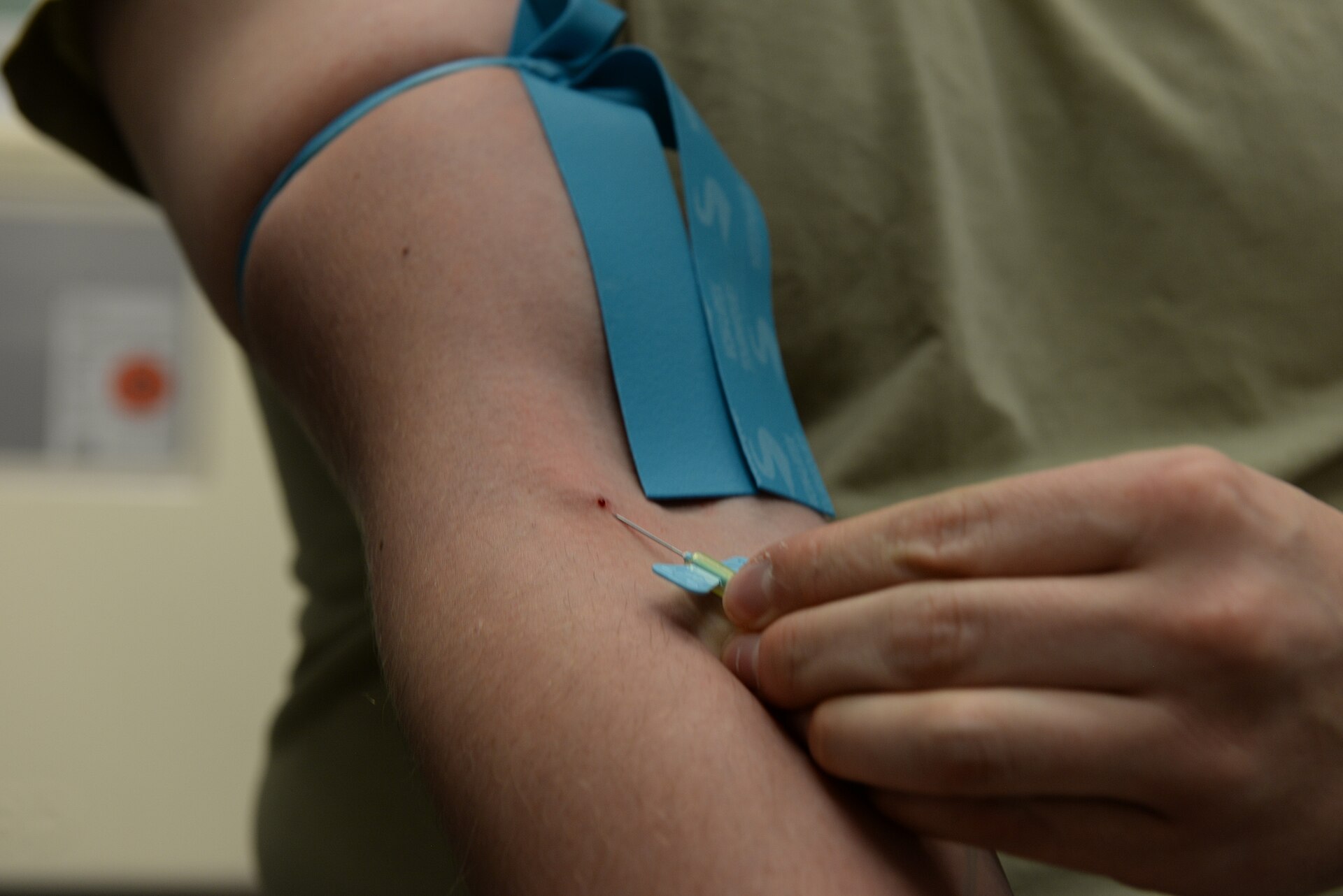 Blood being drawn from a patient's arm at a clinic
